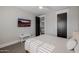 A serene bedroom with a ceiling fan, a mounted TV, and a doorway to another room at 3955 E Fox Cir, Mesa, AZ 85205