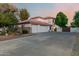 Spacious three-car garage featuring a full driveway, and a two-story home at 3955 E Fox Cir, Mesa, AZ 85205