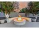 Inviting backyard fire pit with built-in seating, perfect for cozy evenings under the stars at 3955 E Fox Cir, Mesa, AZ 85205