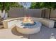 Close up outdoor fire pit with built-in seating at 3955 E Fox Cir, Mesa, AZ 85205