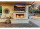 Cozy outdoor fireplace featuring a mounted TV and decorative elements at 3955 E Fox Cir, Mesa, AZ 85205