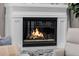 Inviting fireplace with a decorative white mantel and glass front, perfect for cozy evenings at 3955 E Fox Cir, Mesa, AZ 85205