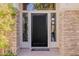 Grand front door with sidelights, showcasing the home's inviting entrance and stone accents at 3955 E Fox Cir, Mesa, AZ 85205
