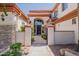 Elegant front entrance with a decorative iron gate and beautifully landscaped walkway at 3955 E Fox Cir, Mesa, AZ 85205