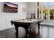 Recreational game room showcasing a pool table and a wall-mounted television for entertainment at 3955 E Fox Cir, Mesa, AZ 85205