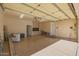 Spacious three car garage with neutral painted walls and overhead lighting at 3955 E Fox Cir, Mesa, AZ 85205