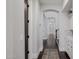 Hallway with arched doorways, wood floors, and white baseboards at 3955 E Fox Cir, Mesa, AZ 85205