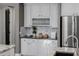 Charming kitchen featuring white cabinets, granite countertops, and a stylish tile backsplash, perfect for culinary enthusiasts at 3955 E Fox Cir, Mesa, AZ 85205