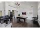 Bright and airy living room with high ceilings, a grand piano, and a classic pool table at 3955 E Fox Cir, Mesa, AZ 85205