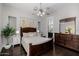 Spacious main bedroom with a wood bed frame, dresser, and an ensuite bathroom at 3955 E Fox Cir, Mesa, AZ 85205