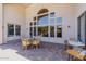 Covered patio seating area with dining table and comfortable chairs at 3955 E Fox Cir, Mesa, AZ 85205