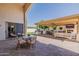 Expansive outdoor living area with full kitchen, bar, outdoor dining, comfortable seating and grassy play area at 3955 E Fox Cir, Mesa, AZ 85205