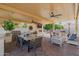 Spacious covered outdoor living area featuring full outdoor kitchen, dining, seating area, fireplace and television at 3955 E Fox Cir, Mesa, AZ 85205