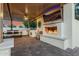 Inviting outdoor space with a fireplace, TV, grill, dining area, and fire pit at 3955 E Fox Cir, Mesa, AZ 85205