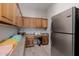 Well-equipped pantry boasts generous cabinet space and a stainless steel refrigerator at 3955 E Fox Cir, Mesa, AZ 85205