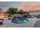 Stunning pool and spa with rock waterfall feature create a resort-like oasis in the backyard at 3955 E Fox Cir, Mesa, AZ 85205