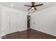 This bedroom features a closet, ceiling fan, and wood-look floors at 4134 W Camino Acequia --, Phoenix, AZ 85051