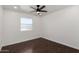 Clean, bright bedroom with wood-look floors featuring a window and overhead fan at 4134 W Camino Acequia --, Phoenix, AZ 85051