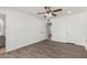 Spacious bedroom featuring wood-look floors, neutral walls, and view to the attached bath at 4134 W Camino Acequia --, Phoenix, AZ 85051