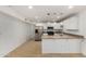 Bright kitchen featuring stainless steel appliances, white cabinetry, and stylish pendant lighting at 4134 W Camino Acequia --, Phoenix, AZ 85051