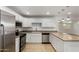 Well-equipped kitchen with stainless steel appliances, white cabinetry, and modern fixtures at 4134 W Camino Acequia --, Phoenix, AZ 85051