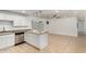 Open kitchen boasts stainless steel appliances and countertops, seamlessly flowing into the living area at 4134 W Camino Acequia --, Phoenix, AZ 85051
