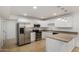 Modern kitchen featuring stainless steel appliances, white cabinetry, and stylish pendant lighting at 4134 W Camino Acequia --, Phoenix, AZ 85051