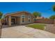 Cozy backyard featuring a concrete patio, small lawn and charming string lights for outdoor entertaining at 4241 E Bonanza Rd, Gilbert, AZ 85297