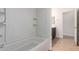 Bright bathroom features a tiled shower and tub surround, and a tiled floor at 4241 E Bonanza Rd, Gilbert, AZ 85297