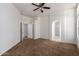 Spacious bedroom with carpeting, ceiling fan, and access to the bathroom at 4241 E Bonanza Rd, Gilbert, AZ 85297