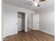 The bedroom features wood-look floors, a ceiling fan and a spacious closet at 4241 E Bonanza Rd, Gilbert, AZ 85297