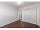 This bedroom has wood floors, white walls and a ceiling fan for comfort at 4241 E Bonanza Rd, Gilbert, AZ 85297