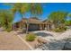 A single-story home featuring desert landscaping with a two-car garage and a well-kept lawn at 4241 E Bonanza Rd, Gilbert, AZ 85297