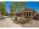 Single-story home with desert landscaping and a two-car garage, complete with sidewalks and trees at 4241 E Bonanza Rd, Gilbert, AZ 85297
