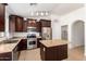 Kitchen with stainless steel appliances, tile floor, and dark wood cabinets at 4241 E Bonanza Rd, Gilbert, AZ 85297