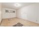 Spacious bedroom with white walls, a window and worn floors at 4553 N 54Th Ave, Phoenix, AZ 85031