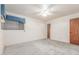 Bedroom featuring neutral carpet, ceiling fan, window, and closet space at 4553 N 54Th Ave, Phoenix, AZ 85031