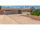Charming single-story home featuring a long driveway and neutral-toned exterior at 4553 N 54Th Ave, Phoenix, AZ 85031