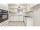 Well-lit kitchen with white cabinets, tile flooring, and appliances at 4553 N 54Th Ave, Phoenix, AZ 85031