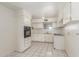 Bright kitchen with white cabinets, built-in oven, and tiled flooring at 4553 N 54Th Ave, Phoenix, AZ 85031