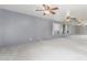 Spacious living room with carpet flooring, ceiling fans, and a view to an open area at 4553 N 54Th Ave, Phoenix, AZ 85031