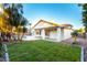 Lush backyard featuring a swimming pool, grassy lawn, and covered patio ideal for outdoor living at 5426 E Karen Dr, Scottsdale, AZ 85254
