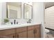 Modern bathroom featuring double sinks, stylish fixtures, and a shower with a striped curtain at 5426 E Karen Dr, Scottsdale, AZ 85254