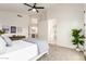 Bedroom with gray carpet, ceiling fan, and ensuite bathroom and kitchen access at 5426 E Karen Dr, Scottsdale, AZ 85254
