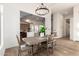 Elegant dining room area with rustic wood table, stylish chandelier, and open view to the kitchen at 5426 E Karen Dr, Scottsdale, AZ 85254