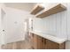 Stylish hallway with built-in storage cabinets, quartz counters, and wood shelves at 5426 E Karen Dr, Scottsdale, AZ 85254