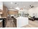 Spacious kitchen featuring an island with seating, stainless steel appliances, and open view to living area at 5426 E Karen Dr, Scottsdale, AZ 85254