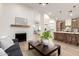 Open-concept living space with fireplace, views of the dining area, and a kitchen with island seating at 5426 E Karen Dr, Scottsdale, AZ 85254