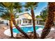 Backyard view showcasing the refreshing pool, covered patio, and well-maintained landscaping at 5426 E Karen Dr, Scottsdale, AZ 85254