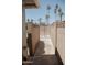View down block wall of backyard with palm trees, rock, and potential pool at 5602 W Heatherbrae Dr, Phoenix, AZ 85031